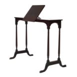 An early 20th century mahogany mobile writing table with an adjustable slope and ratchet