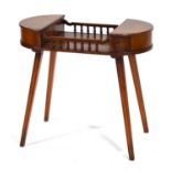 A late 20th century ladies work table in yew, the pair of D-end lifting lids joined by a galleried