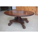 A William IV and later walnut and mahogany crossbanded centre table, the oval surface resting on a