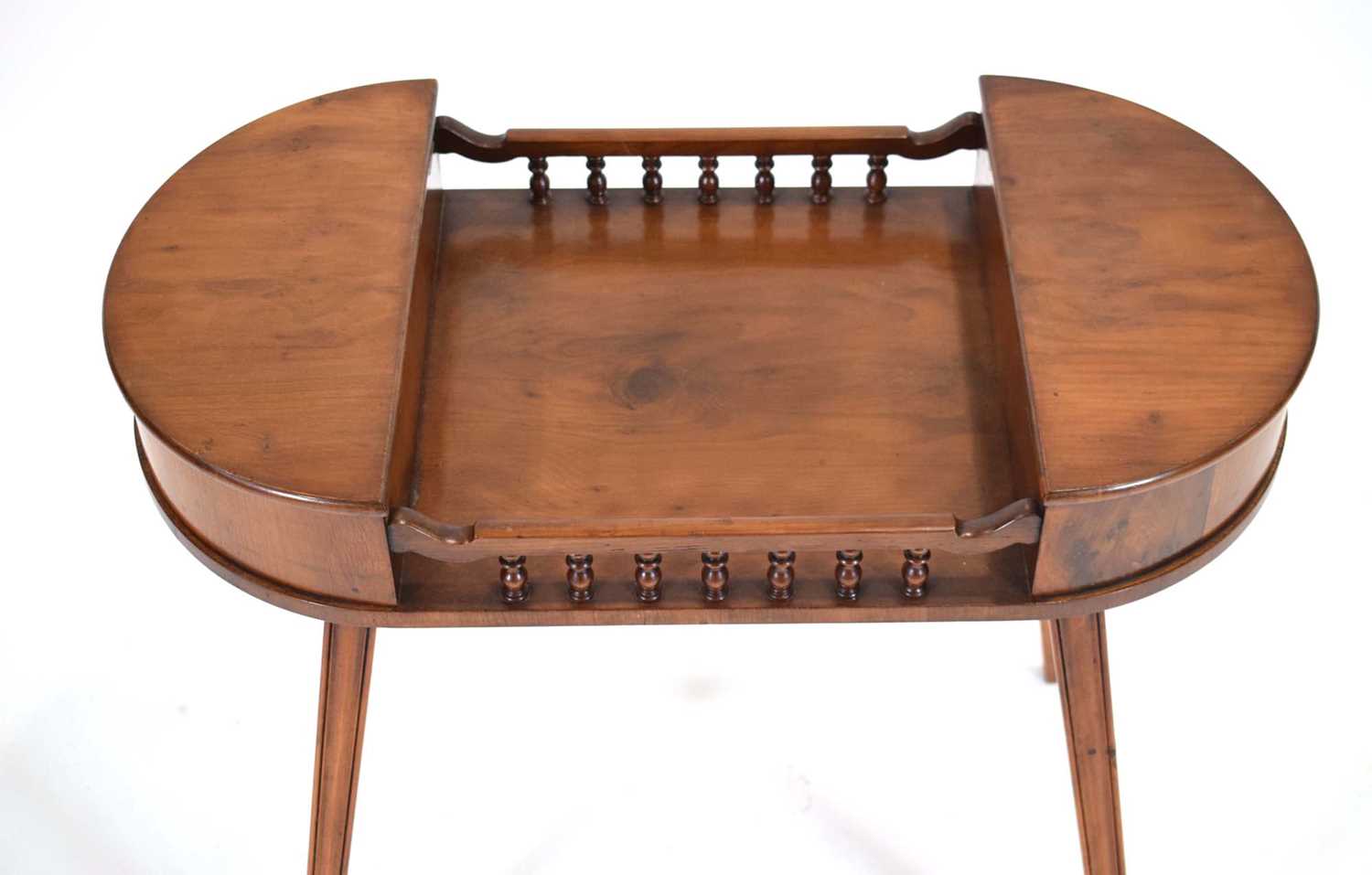 A late 20th century ladies work table in yew, the pair of D-end lifting lids joined by a galleried - Image 3 of 3