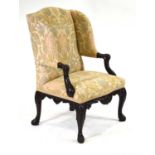 A 19th century 'Gainsborough' or library elbow chair in the Chippendale manner, the mahogany frame