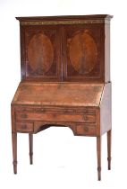 A George III mahogany, ebony and marquetry strung bureau cabinet, the two panelled doors below