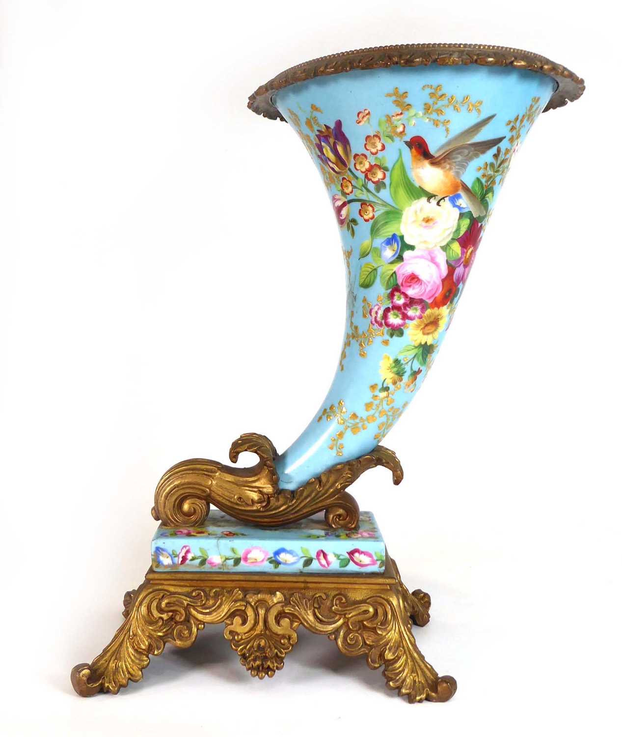 A late 19th/early 20th century gilt metal mounted cornucopia vase decorated with floral sprays and