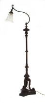 A carved mahogany floor lamp with a cast metal stem, presumably converted from a torchiere
