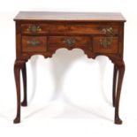 A George II/III and later yew and mahogany lowboy with an arrangement of one long and three short
