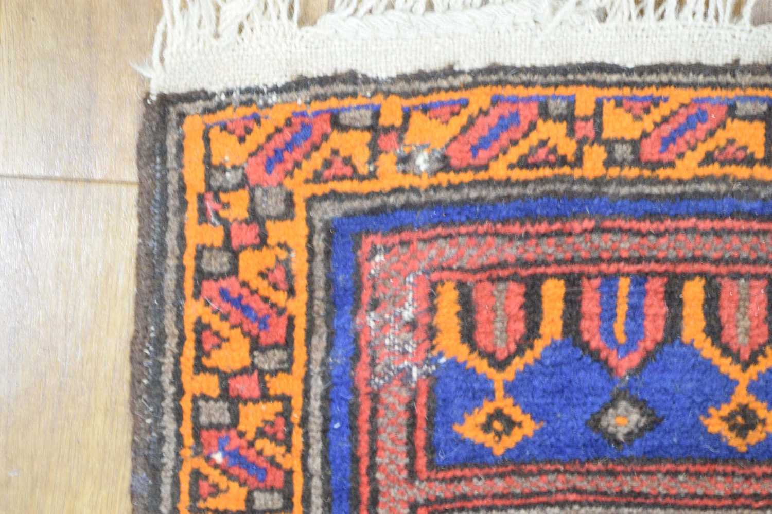 A mid-20th century woollen prayer rug, the blue ground with orange and red architectural motifs, 149 - Image 3 of 4