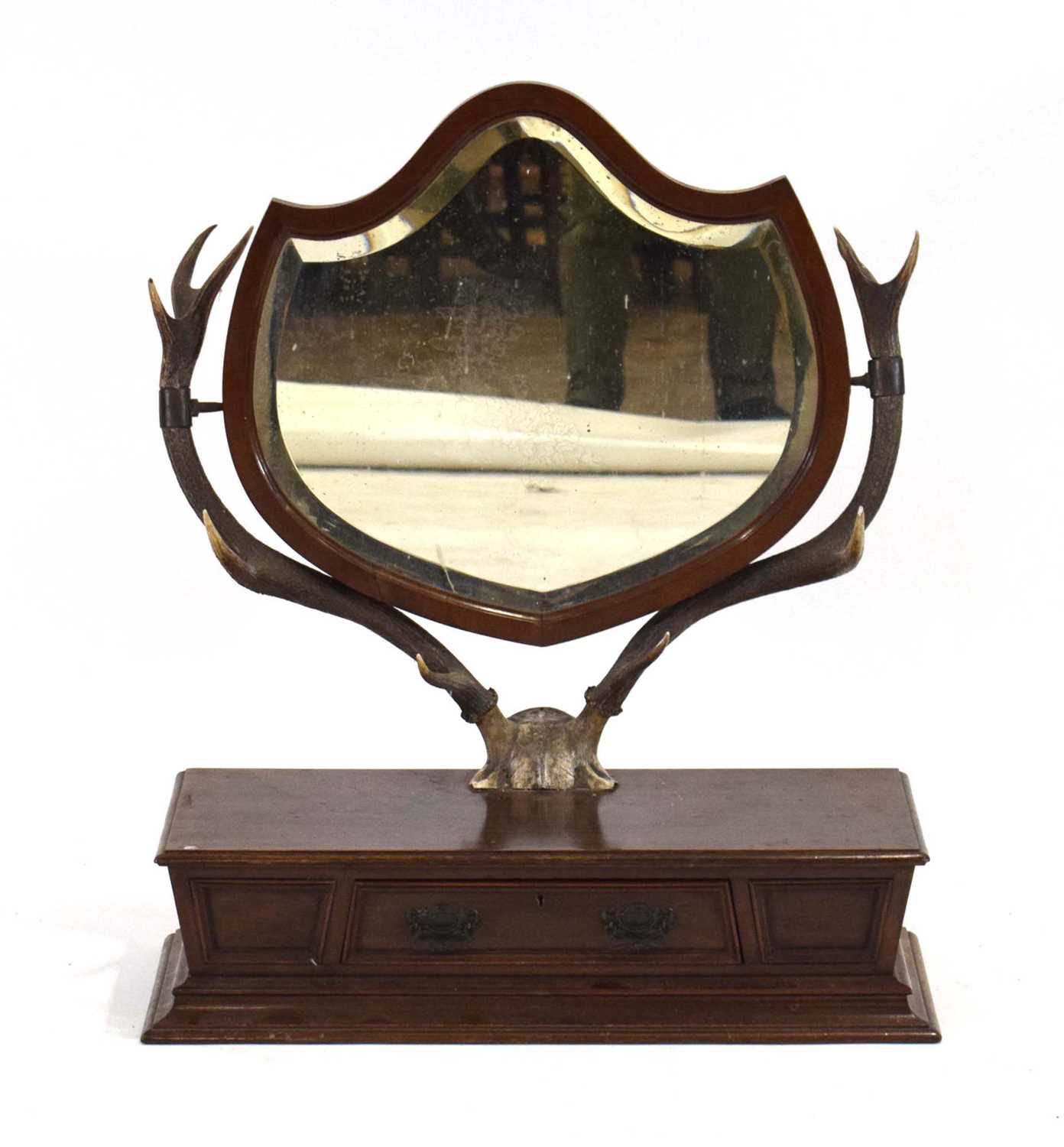 A late 19th century toilet mirror, the shield-shaped bevelled glass mirror supported by a pair of - Image 2 of 2