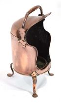 A George III copper plate warmer with a swing handle and three splayed feet, h. 56 cm