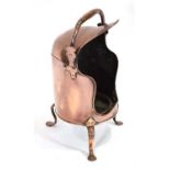 A George III copper plate warmer with a swing handle and three splayed feet, h. 56 cm