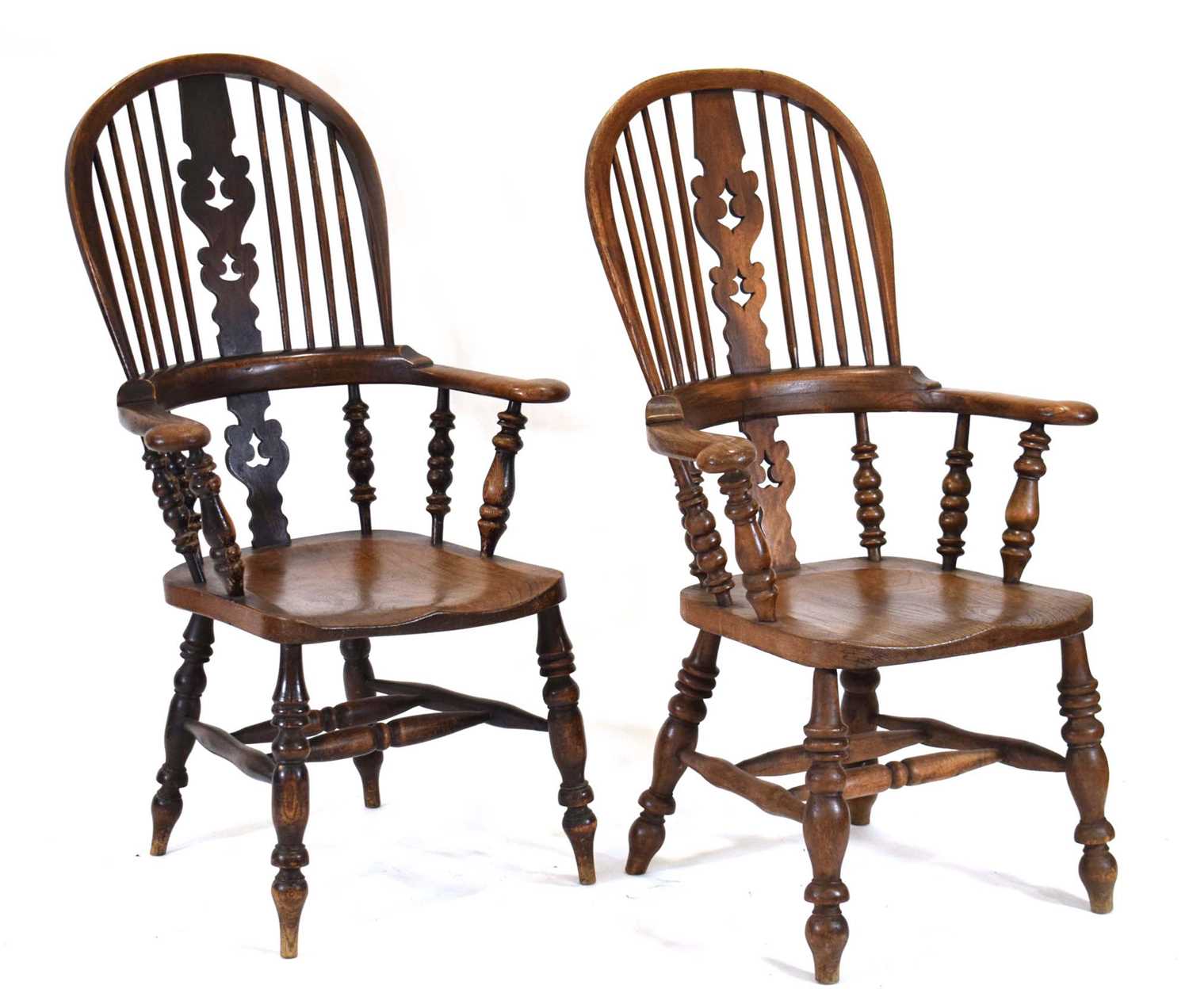 A near pair of 'his and hers' 19th century and later elm and beech Windsor armchairs with shaped