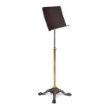 A Victorian music or reading stand, the mahogany slope on a brass adjustable stem and cast iron