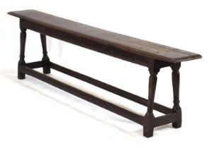 A 17th century oak joint hallway bench with turned supports and stretchers, 197 x 26 cm