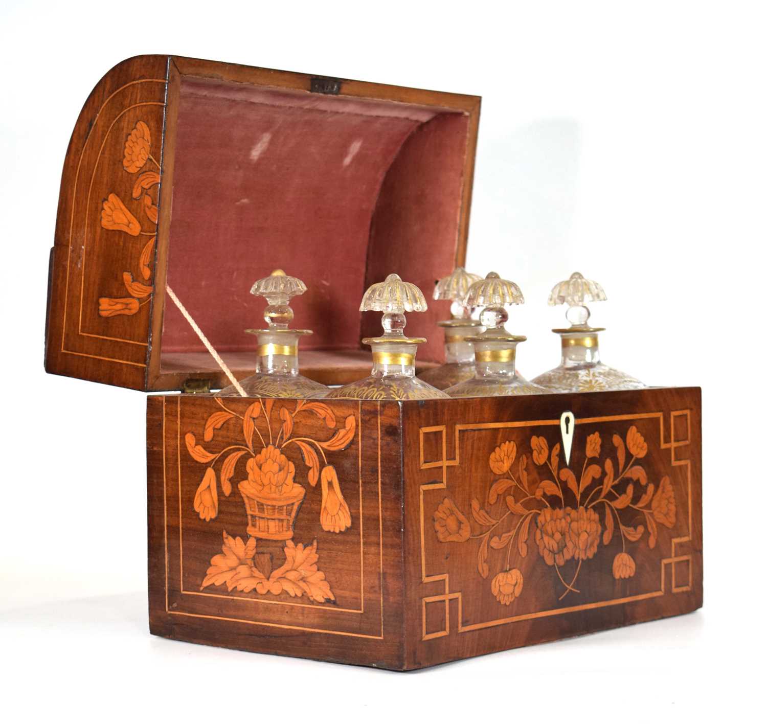 A 19th century French 'six-bottle' tantalus or liqueur cabinet, the marquetry and strung case with a