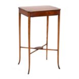 A Sheraton Revival satinwood and strung sewing table, the lift-lid enclosing a fitted interior, on