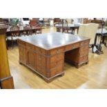 A late 19th/early 20th century mahogany partner's desk, the green tooled leather surface over a