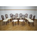 A set of ten Hepplewhite-style mahogany dining chairs including two carvers, upholstered in cream