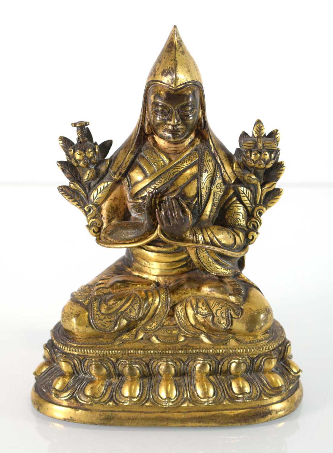 A 19th century Tibetan gilt bronze figure modelled as Tsongkhapa, h. 18 cmSome tarnishing. Base