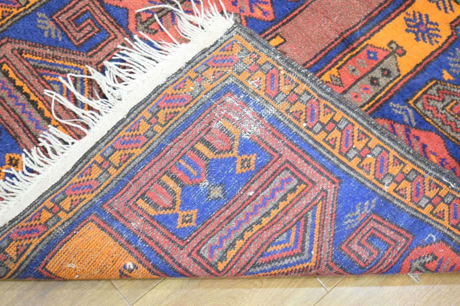 A mid-20th century woollen prayer rug, the blue ground with orange and red architectural motifs, 149 - Image 4 of 4