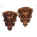 A pair of carved walnut wall sconces, h. 30 cm, w. 30 cm