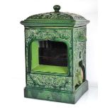 A Doulton 'Smokeless' stove decorated in a plain green glaze, h.51 cm