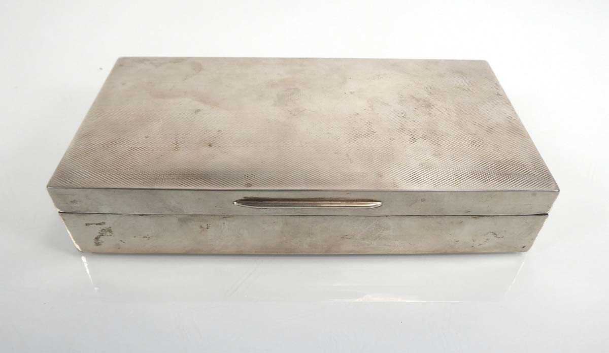 An early 20th century silver engine turned cigarette box, London 1936, w. 17.5 cmNumerous dents - Image 2 of 10