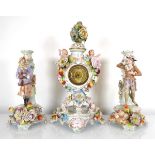 A late 19th/early 20th century mantel timepiece on stand, the gilt movement within a florally
