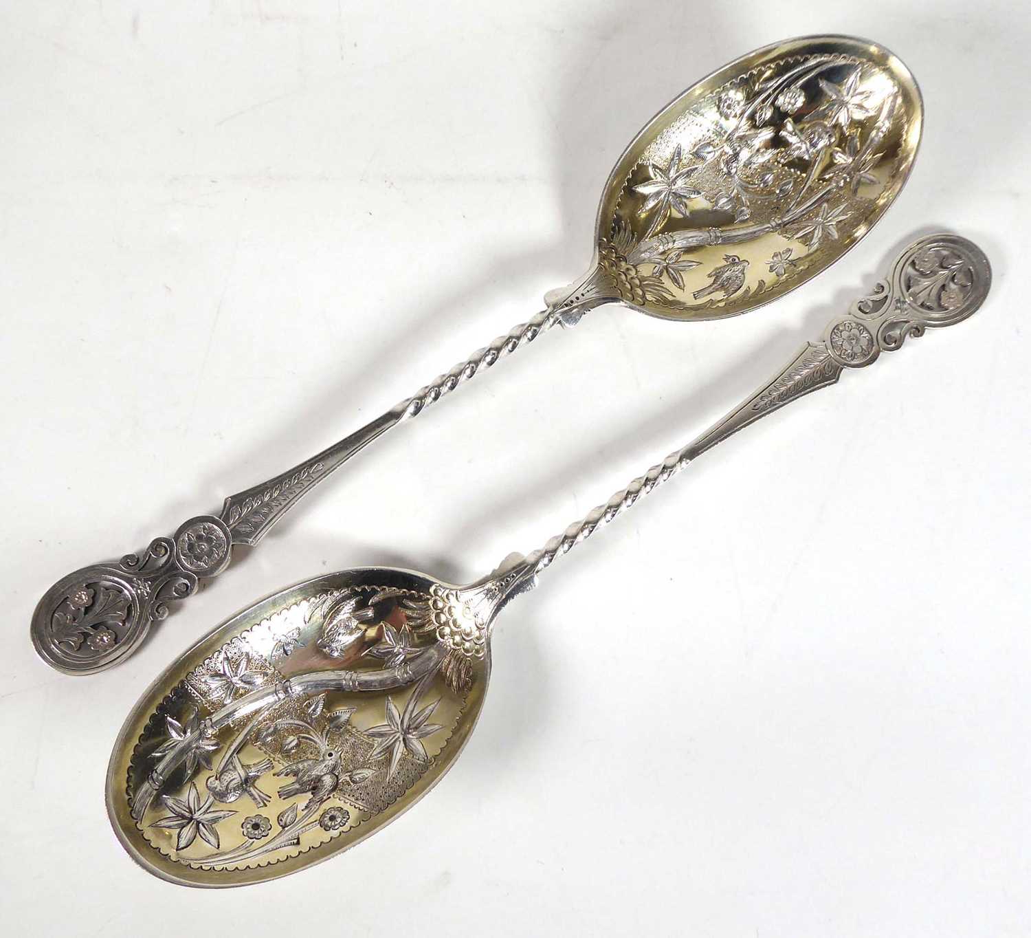 A pair of mid-19th century silver parcel gilt berry spoons, the bowls later engraved in the