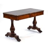 A 19th century rosewood library table of rectangular form, on two baluster supports with claw feet