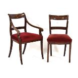 A pair of mahogany marquetry dining chairs, including a carver, in the Dutch manner