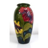 A Moorcroft vase of slender shouldered form decorated with anemone on a green ground, Queen Mary