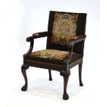 An early 20th century gentleman's library chair, the mahogany frame with acanthus caps, tapestry