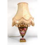 A two handled vase of classical form decorated with floral sprays on a gilt/blue ground, drilled and