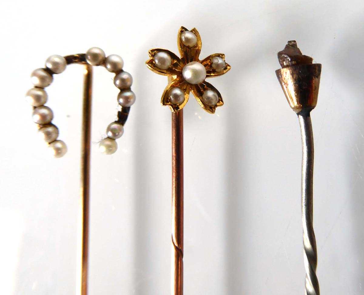 An 18ct yellow gold stick pin set seed pearls in a flowerhead setting, l. 5.8 cm, 1.2 gms and two - Image 2 of 4