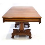 A mid-19th century mahogany three-pillar dining table with turned columns, platform bases and turned