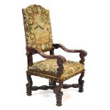 A 19th century Flemish armchair, the oak scrolled frame with needlework upholstery over an X-