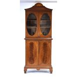 An Edwardian mahogany and strung bookcase cabinet, a sunburst pediment over a pair of glazed doors