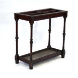 A late 19th century mahogany stick and umbrella stand, four compartments over a drip tray, with