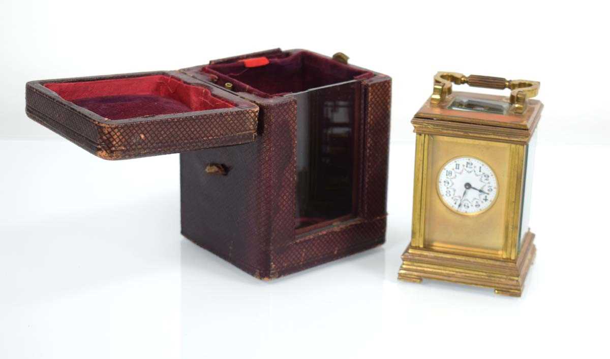 A late 19th century French carriage timepiece with a brass and enamelled dial, Arabic numerals,