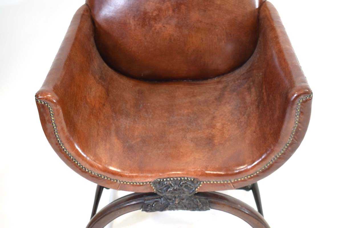 A 19th century mahogany and brown leather club armchair on a carved X-frame bearing a mask of a - Image 6 of 17