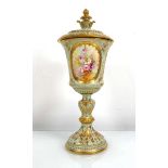 A Royal Bonn covered goblet decorated with floral sprays within a gilt and pale green ground, h.