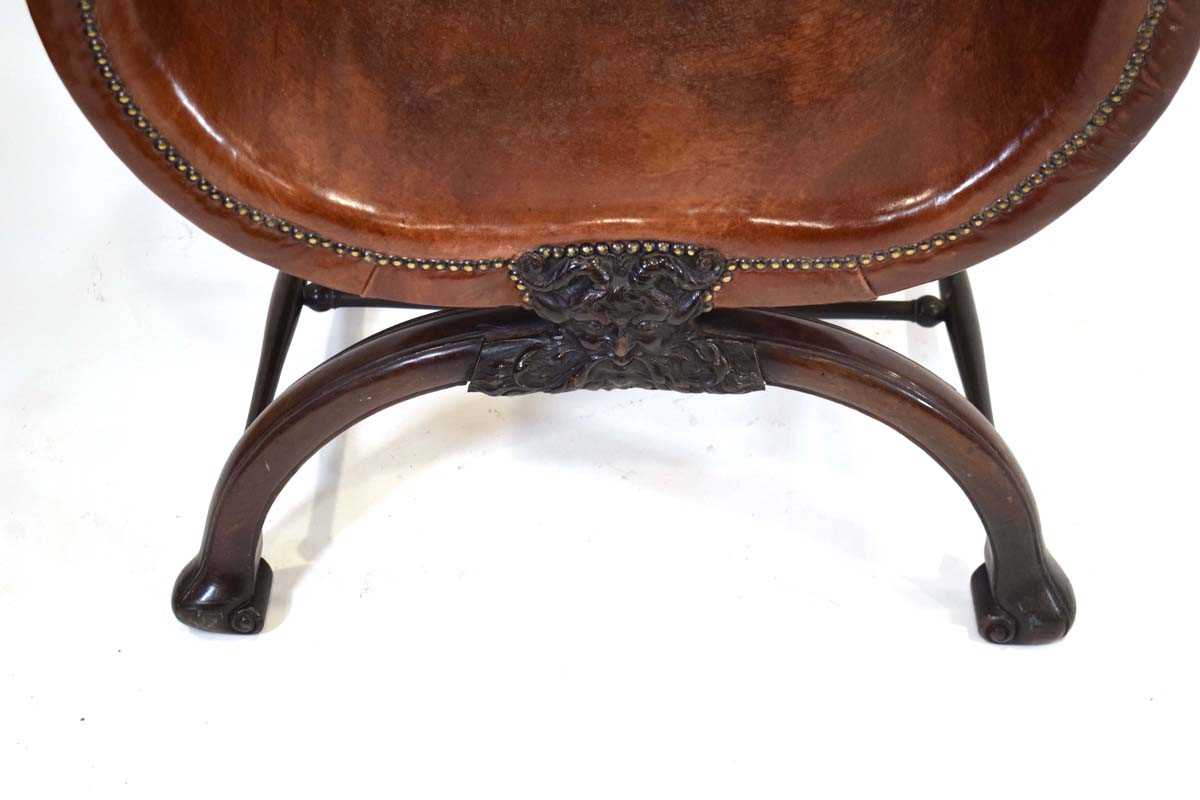 A 19th century mahogany and brown leather club armchair on a carved X-frame bearing a mask of a - Image 5 of 17