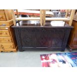 An 18th century and later oak coffer with carved panels and square straight stiles, w. 120 cm