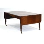 A 19th century mahogany extending dining table in the manner of Gillows, with two fitted leaves