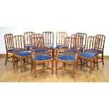 A set of twelve beech dining chairs in the 18th century manner, each with a blue drop-in seat