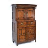 An oak deuddarn or court cupboard in the 18th century manner, with four panelled doors and two