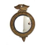 An Atsonea wall mirror with a convex plate surmounted by a bird, h. 59 cm