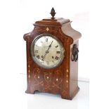 An Edwardian table clock, the movement striking on a gong, the silvered dial inscribed 'W.J.