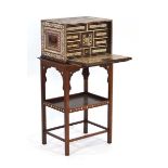 A 19th century Anglo-Indian or Portuguese teak and ivory mounted collector's cabinet, the fall-front