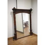 A Victorian carved oak overmantle mirror of imposing proportions with fluted half columns and