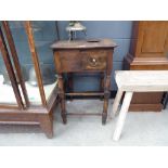 A reproduction beech 'rent' table, the surface with a round hole over a side drawer, on turned legs,